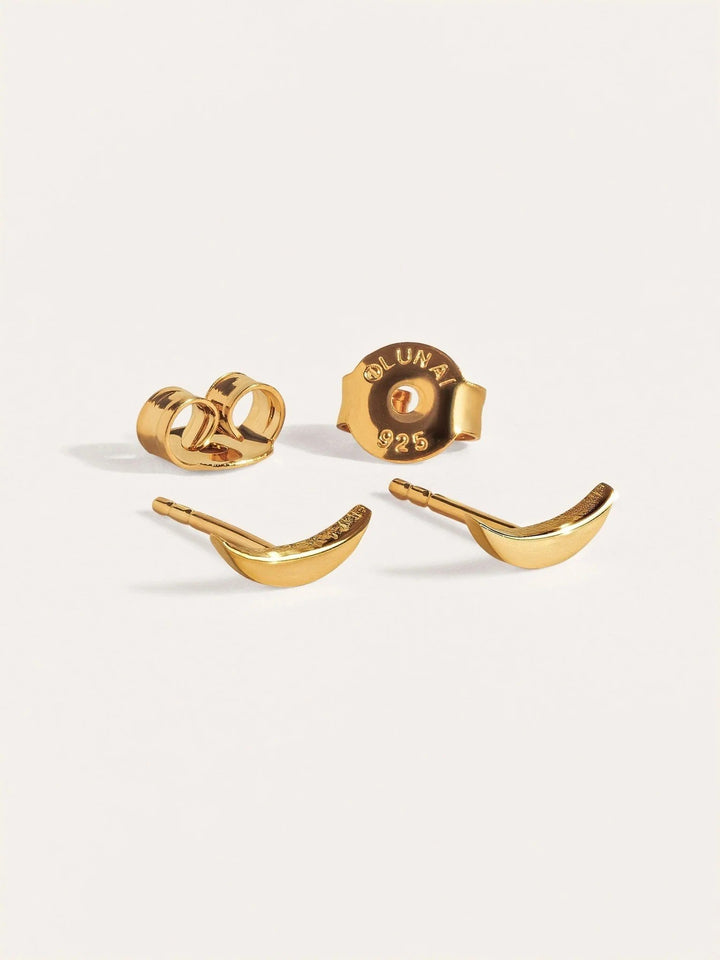 Gold crescent-shaped stud earrings with butterfly backs shown as a set