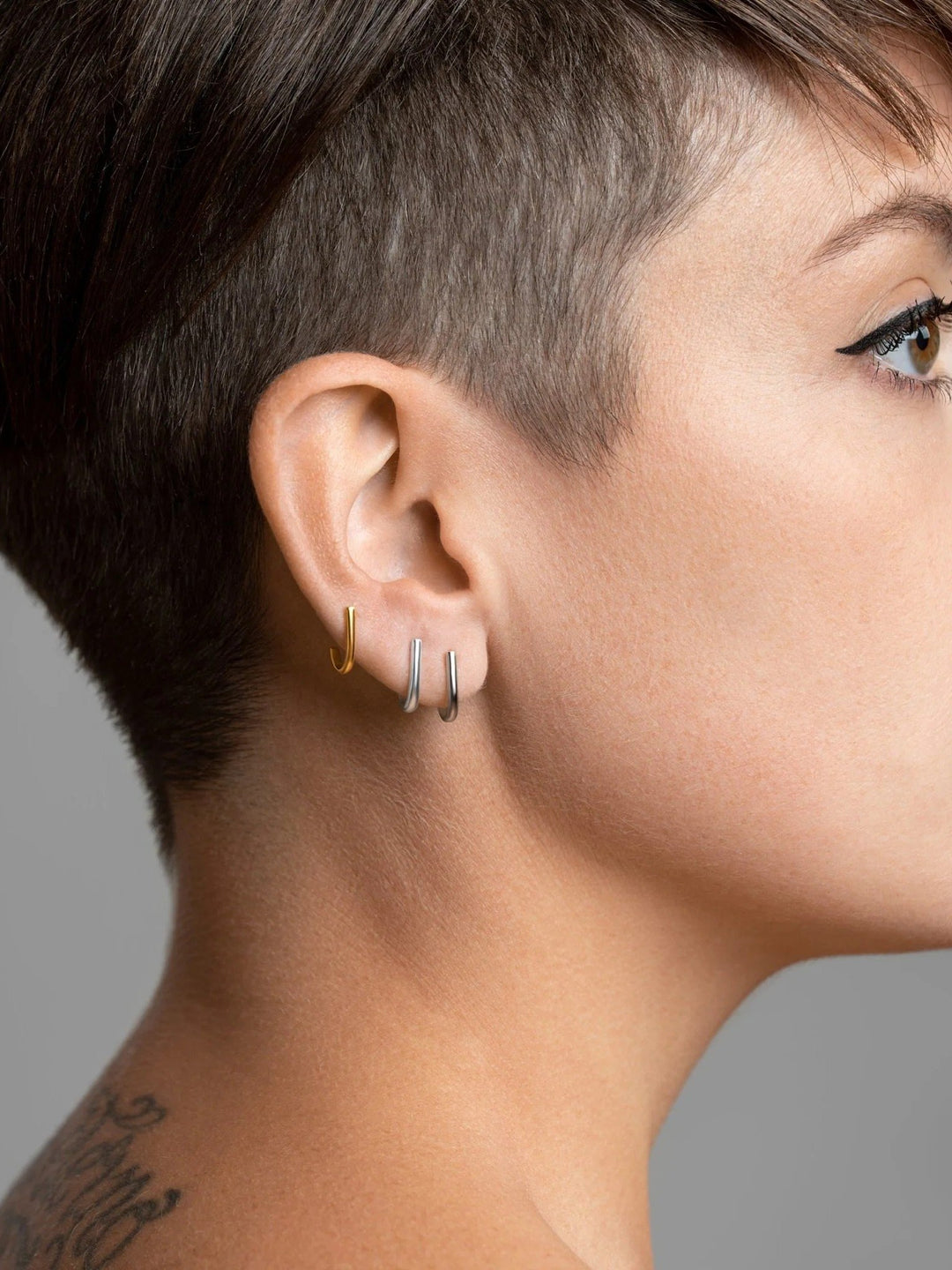 Sita bar earring in sterling silver worn — sculptural and polished for modern styling.