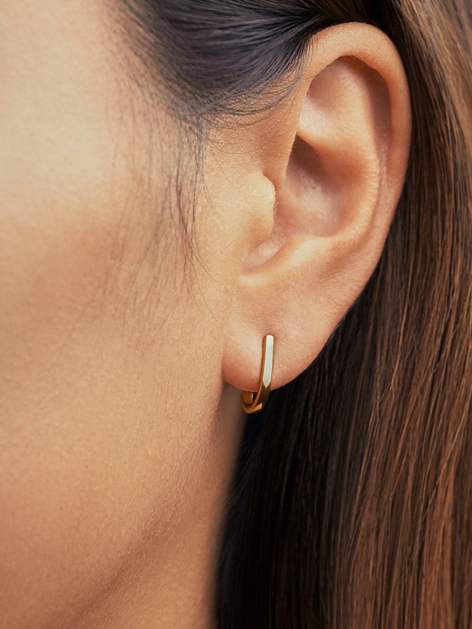 Gold Sita bar earring worn close-up — understated and elegant everyday style.