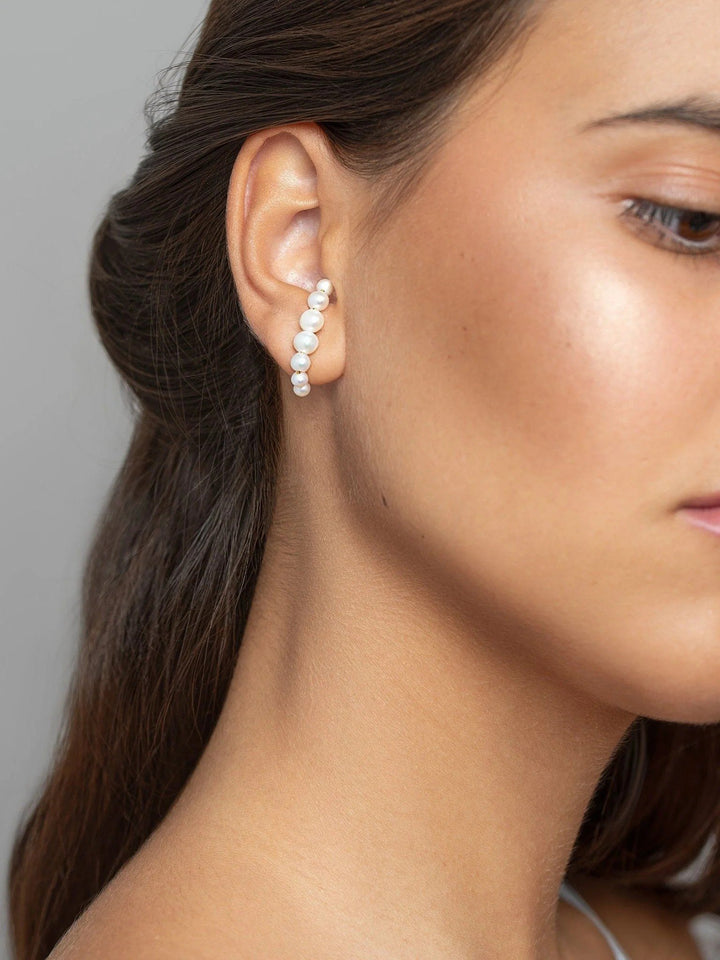 Model facing forward wearing the handmade Solene ear cuff, highlighting its minimalist and modern design.