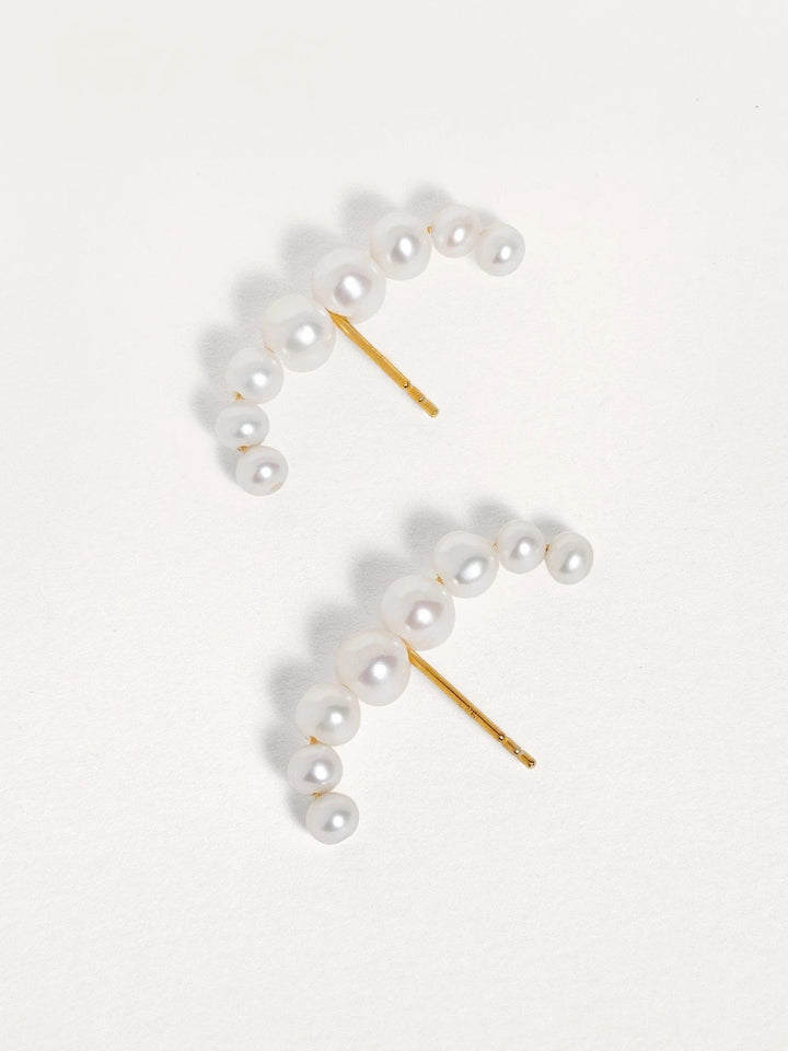 Side view of the Solene ear cuff highlighting the curve and pearl accent on gold-plated sterling silver.