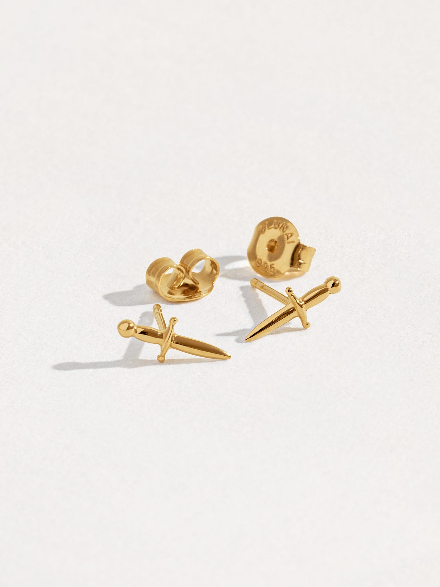 Tessa Sword Stud Earrings in 24K Gold Plated with soft lighting – Jewelry detail shot