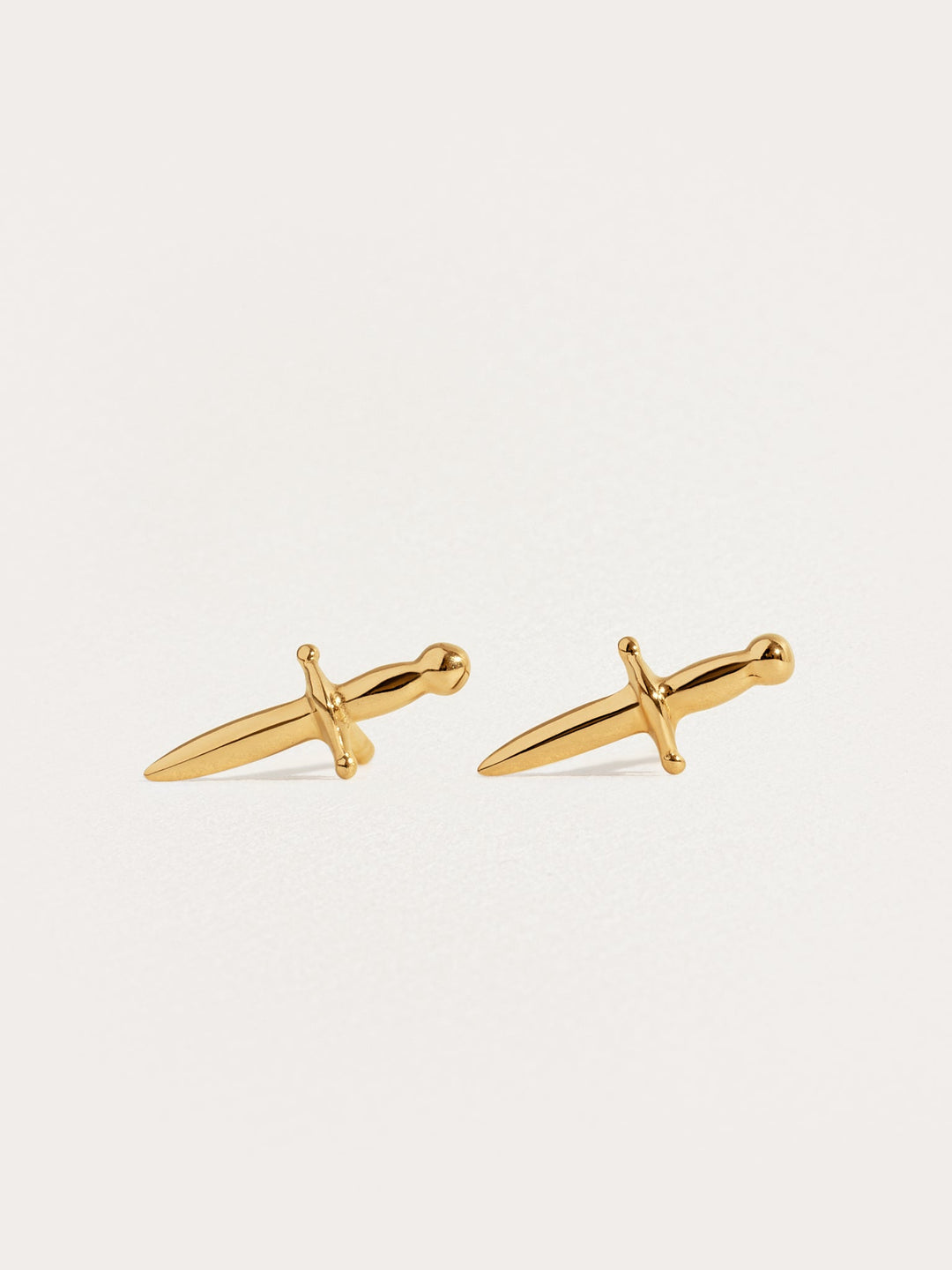 Tessa Sword Stud Earrings in 24K Gold Plated – Minimalist dagger earrings on white background"