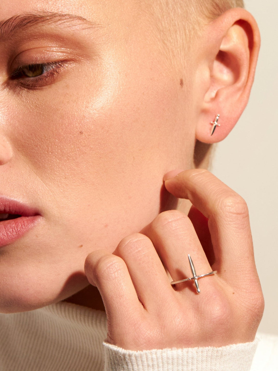 Model adjusting Tessa Sword Stud Earrings – Minimalist everyday jewelry