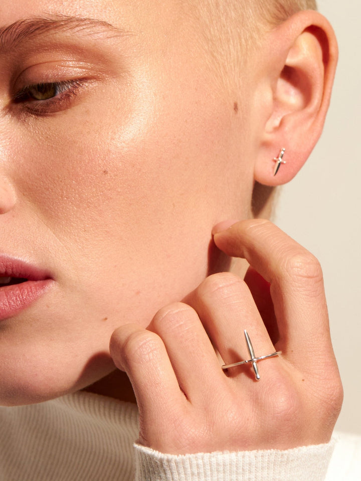 Model adjusting Tessa Sword Stud Earrings – Minimalist everyday jewelry