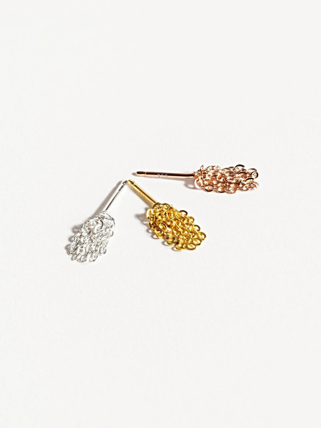 Trio of elegant tassel drop earrings showing gold, rose gold, and silver colorsJewelry