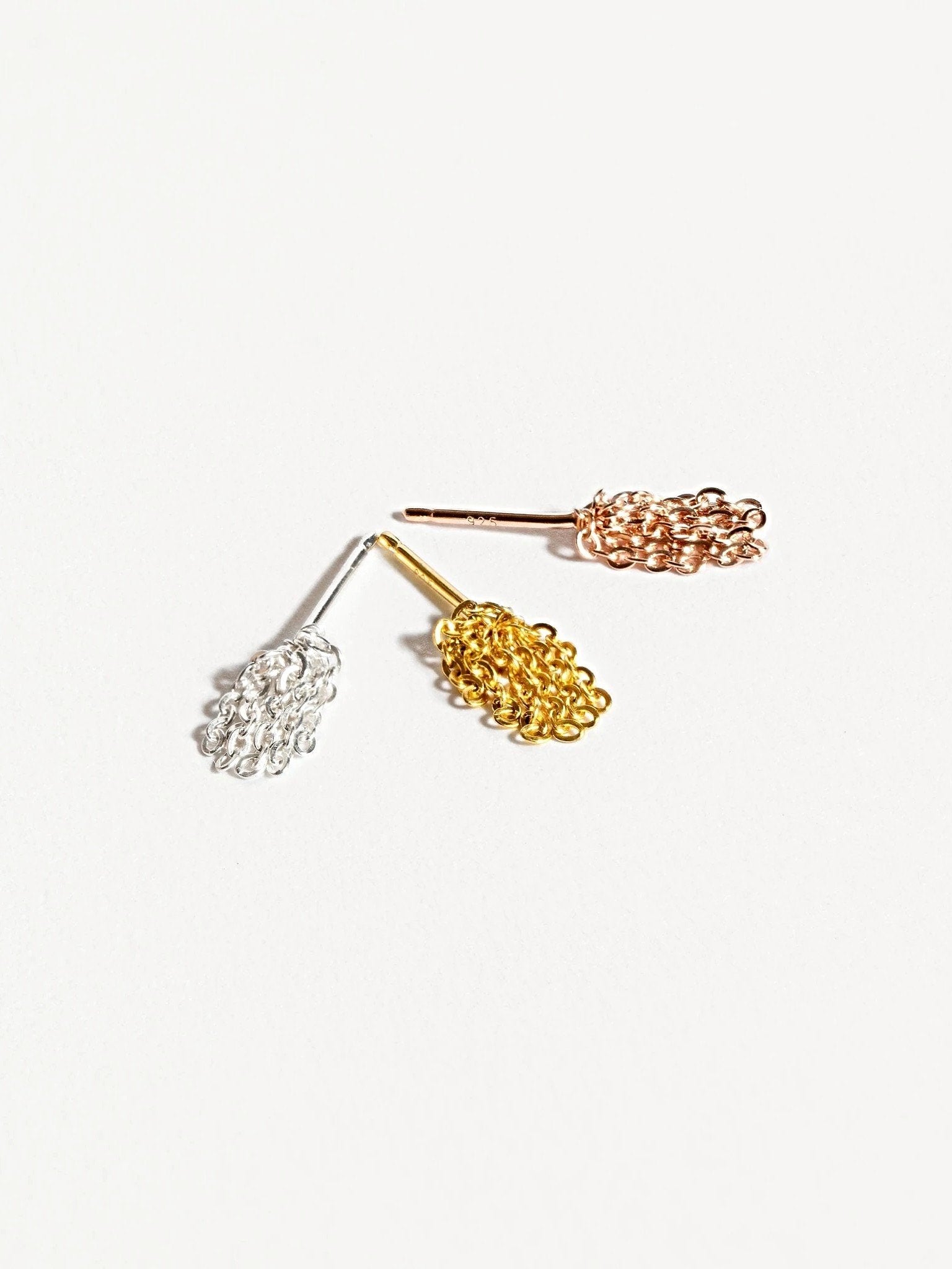 Trio of elegant tassel drop earrings showing gold, rose gold, and silver colorsJewelry