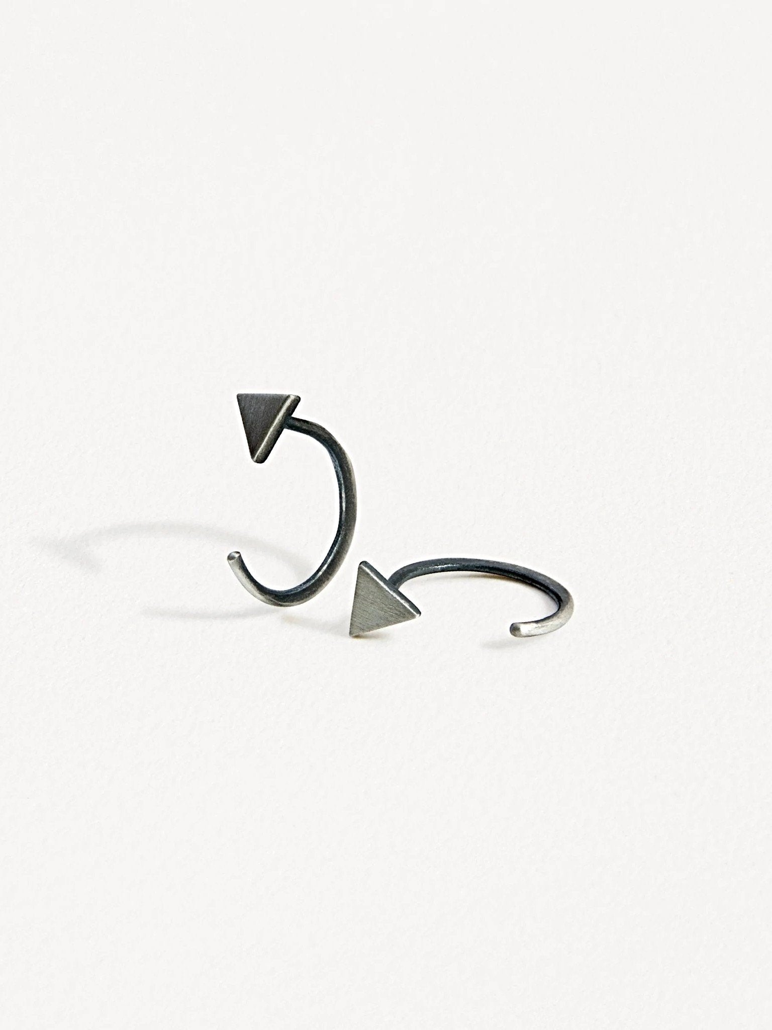 Geometric triangle huggie earrings in oxidized silver finish