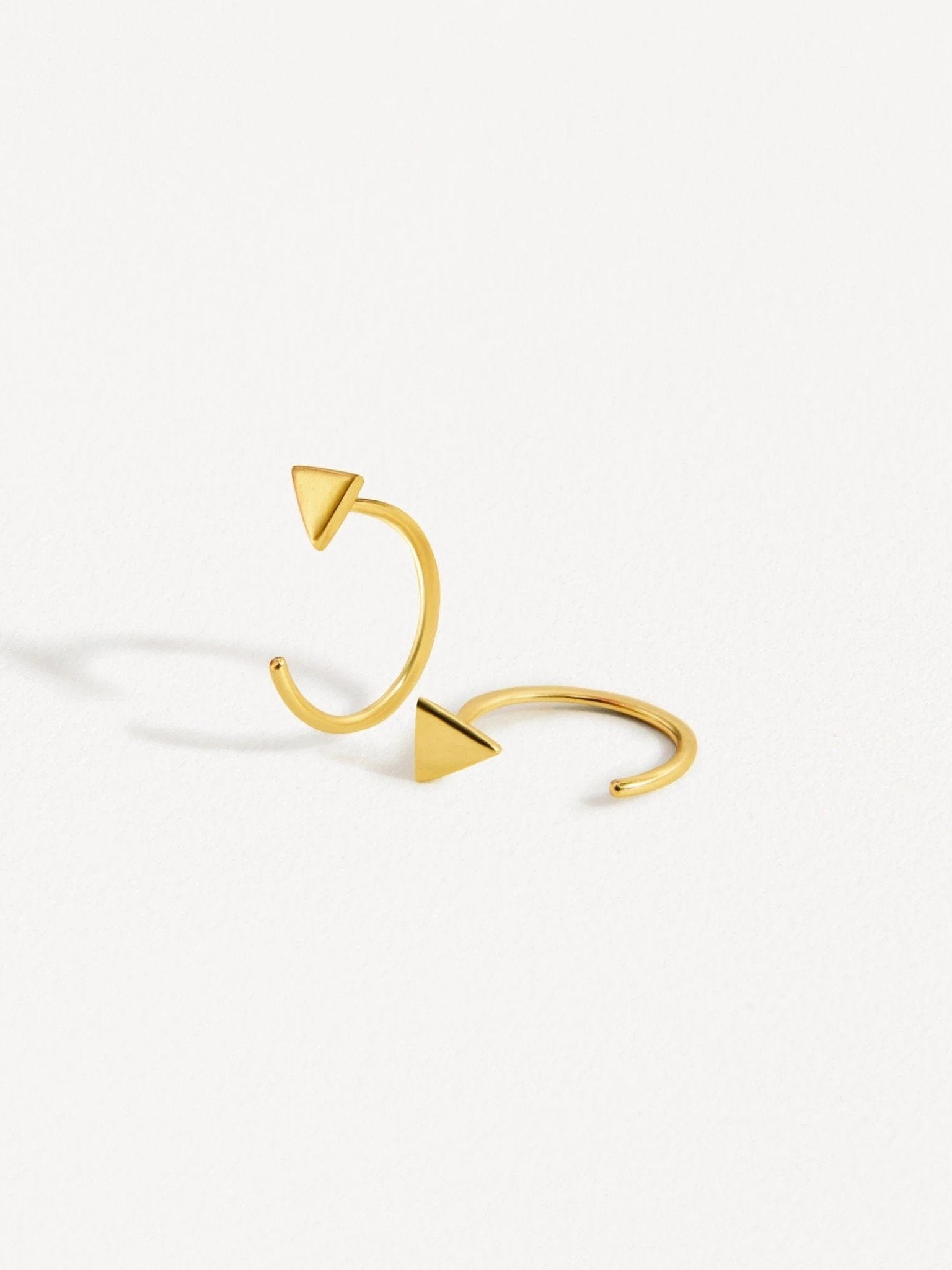 Geometric triangle huggie earrings in yellow gold finish