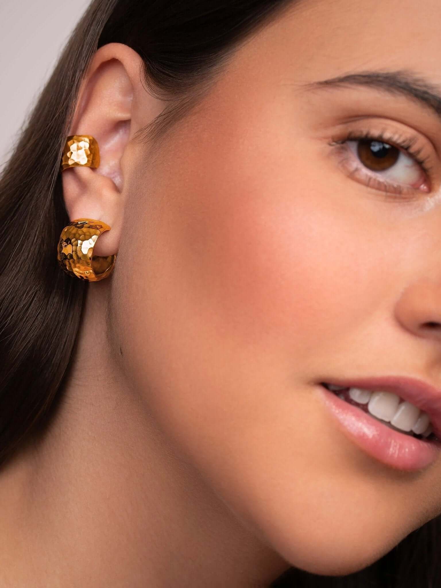 Model wearing the gold hammered conch cuff, styled on the upper ear for a refined look.
