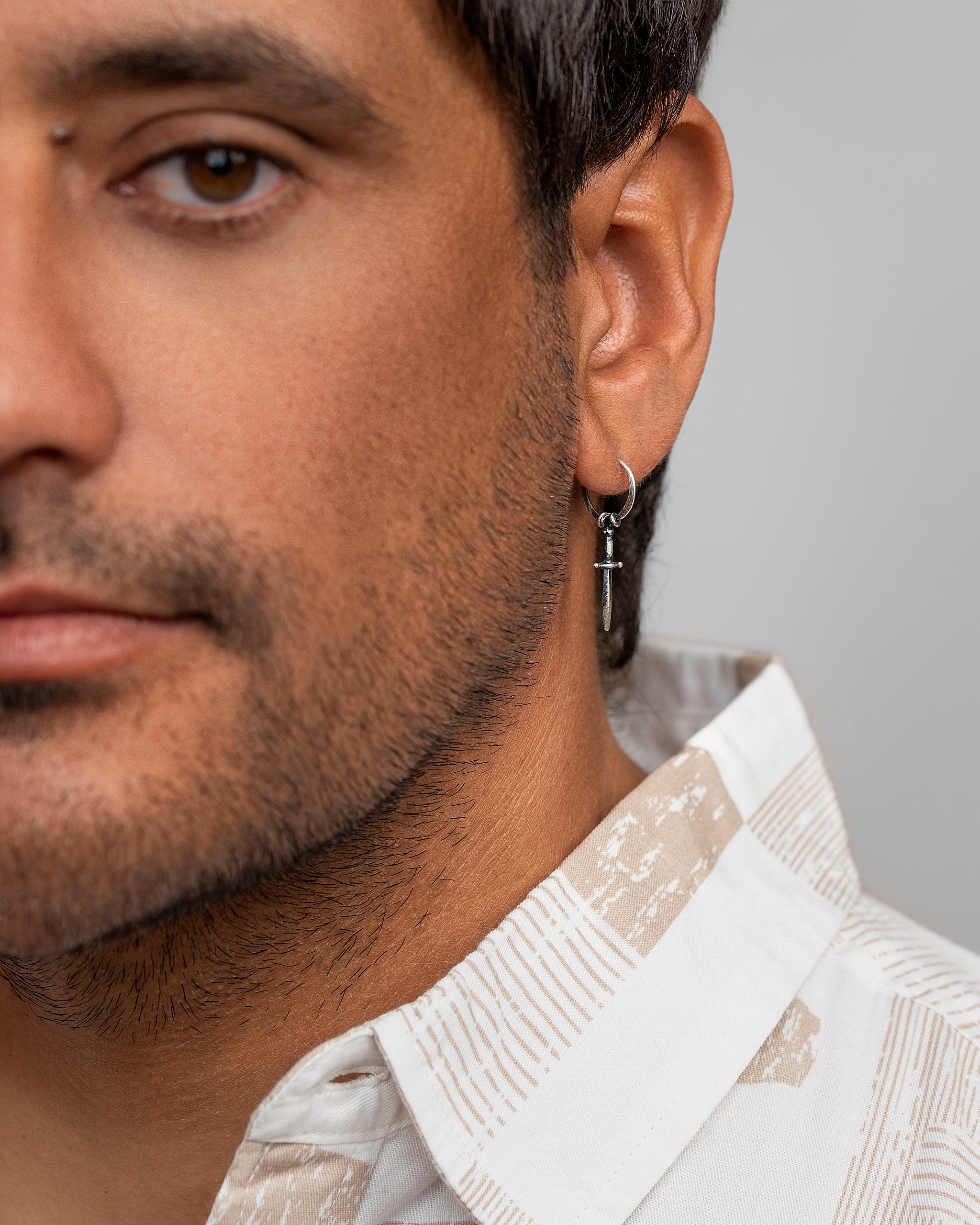 Silver Oxidized Sword Hoop Earrings.Enhance your style with these unique Men's Sword Dangle Hoop Earrings.These hoop earrings are incredibly easy to put on and comfortable. They are so pleased that you could even wear them to sleep in!