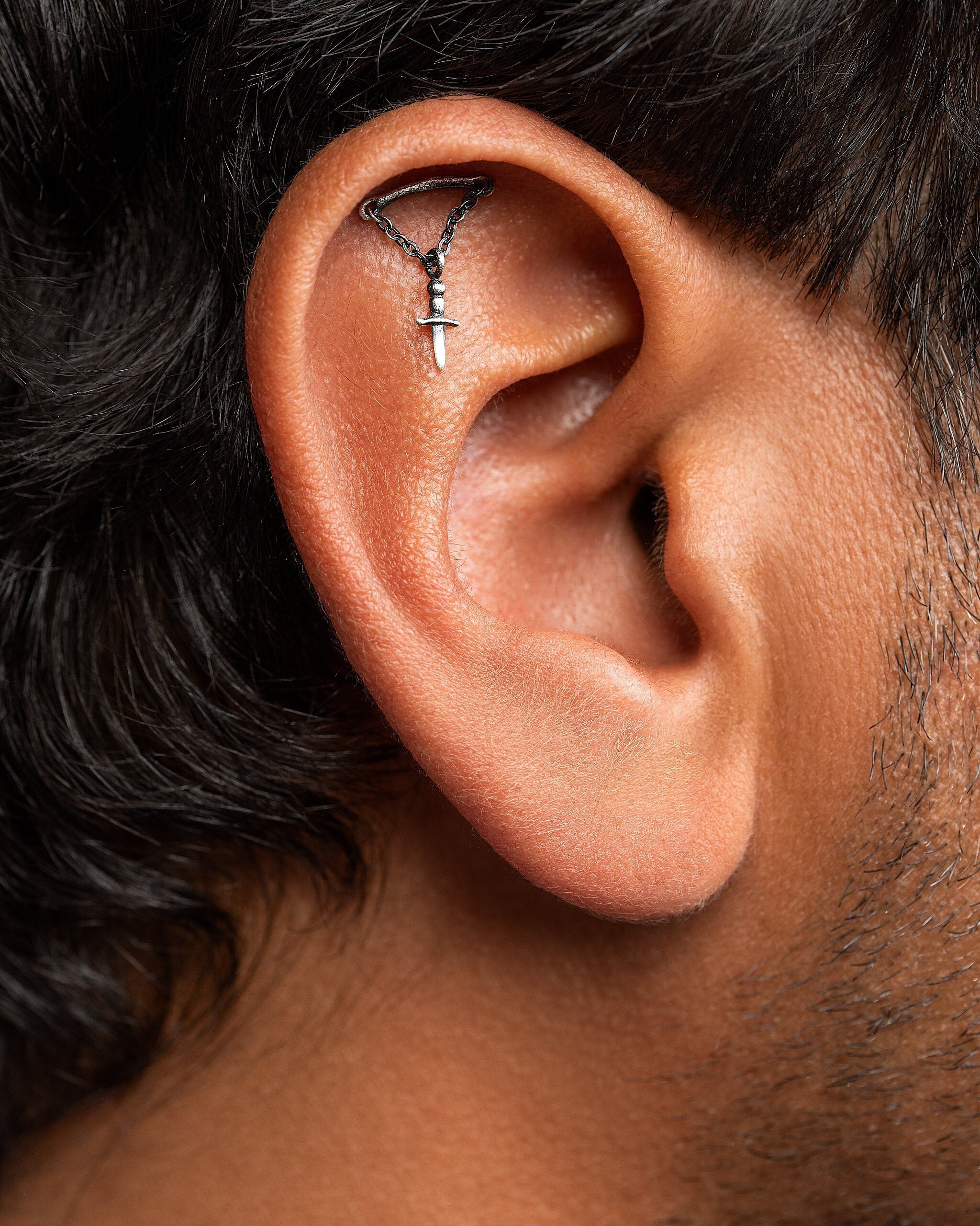 The helix sword shape adds a bold and striking element, while the flat-back dagger details give them an extra dose of attitude. Handcrafted with care, these earrings are sure to make a statement and elevate your look to the next level.