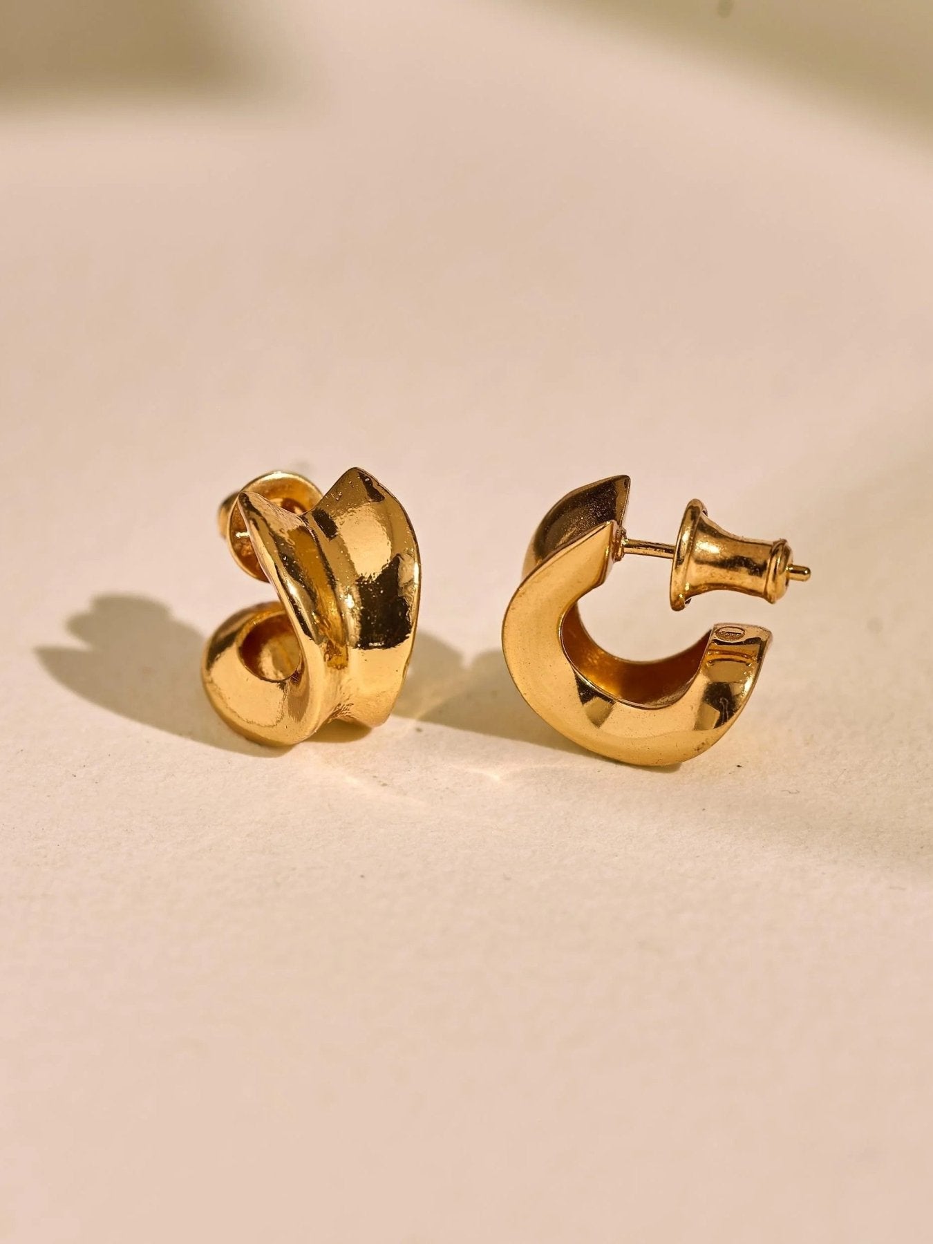 Pair of 24K gold plated small chunky hoop earrings with rounded sculptural shape.
