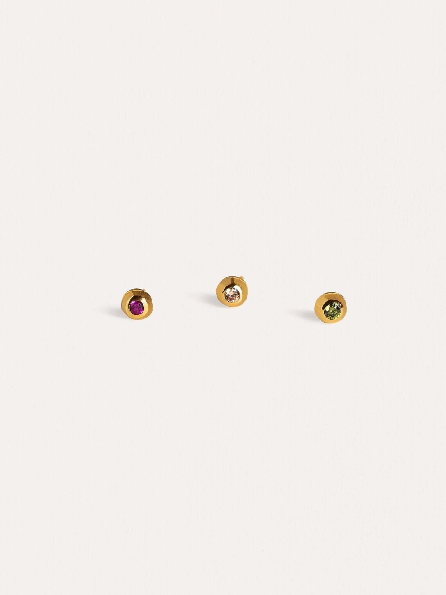 Minimalist gold stud earrings displayed on a clean, white background.