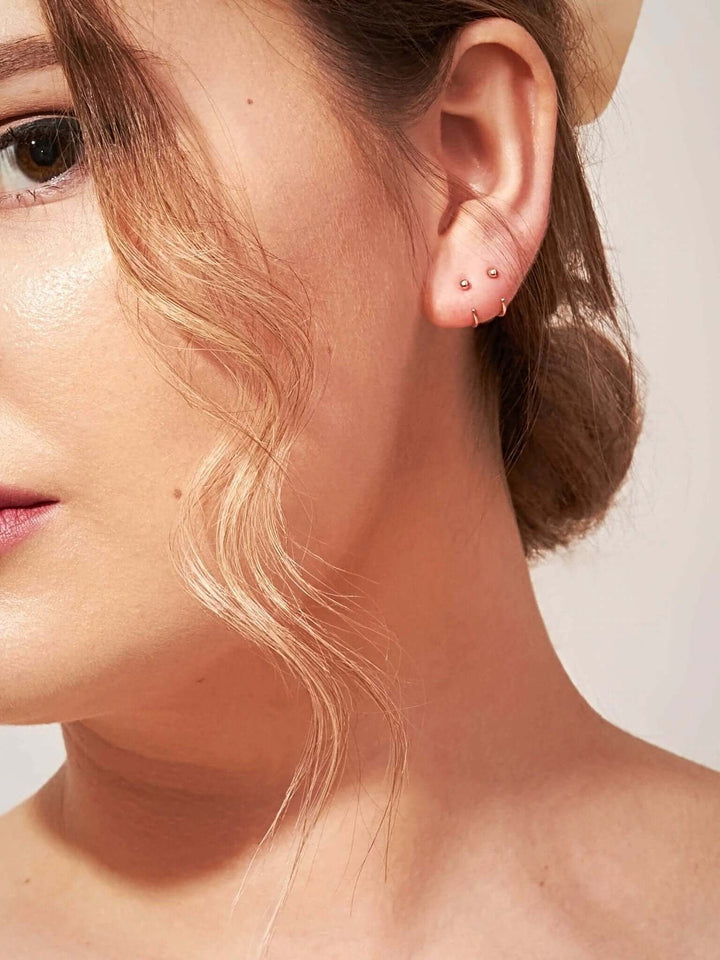 Aalami Gold Huggie Hoop Earrings - 18K Rose Gold Platedcartilage earringsCrystal EarringsLunai Jewelry