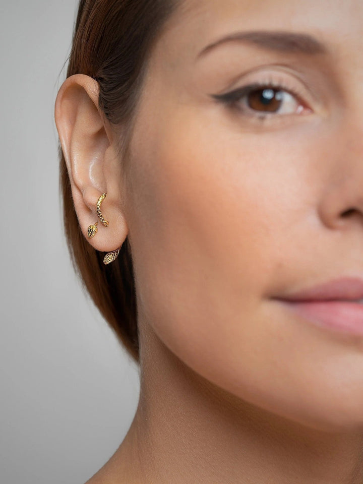 Model wearing a gold-plated snake hoop earring, showing its comfortable fit and stylish look.