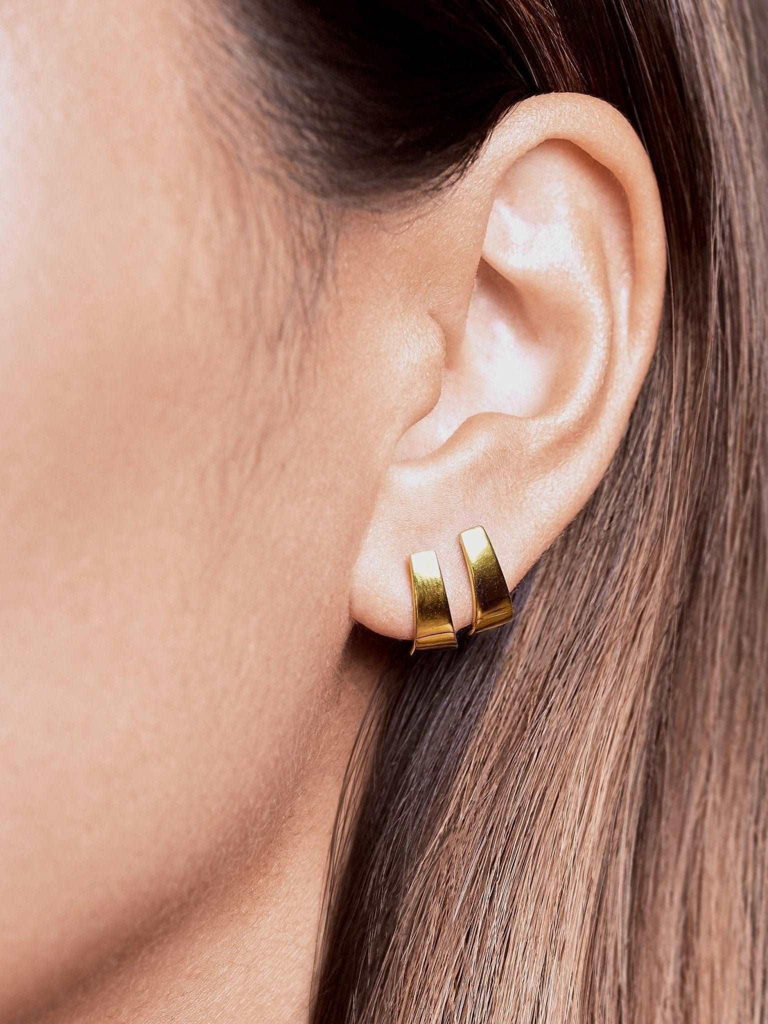 Terita gold stud earring worn — 24K gold plated finish with sculptural shape and warm glow.