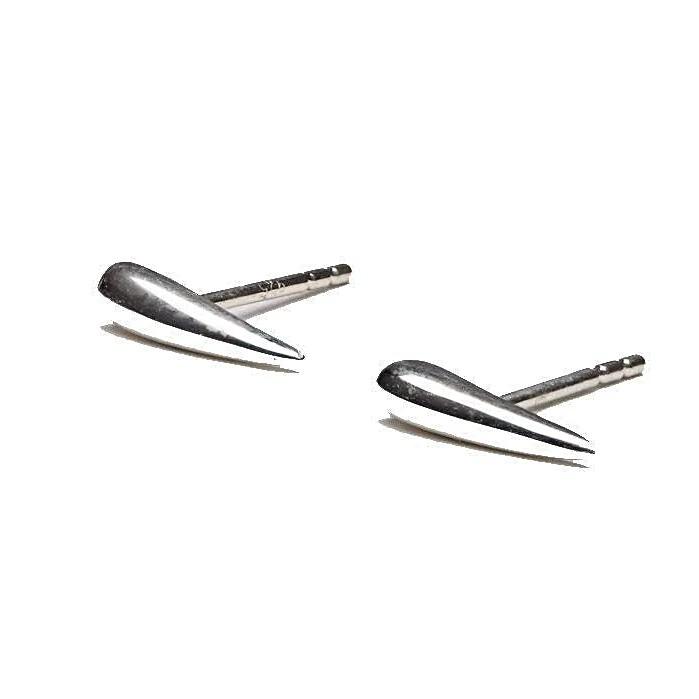 . "Close-up of Aura Dainty Tusk Earrings in silver, showing fine details"