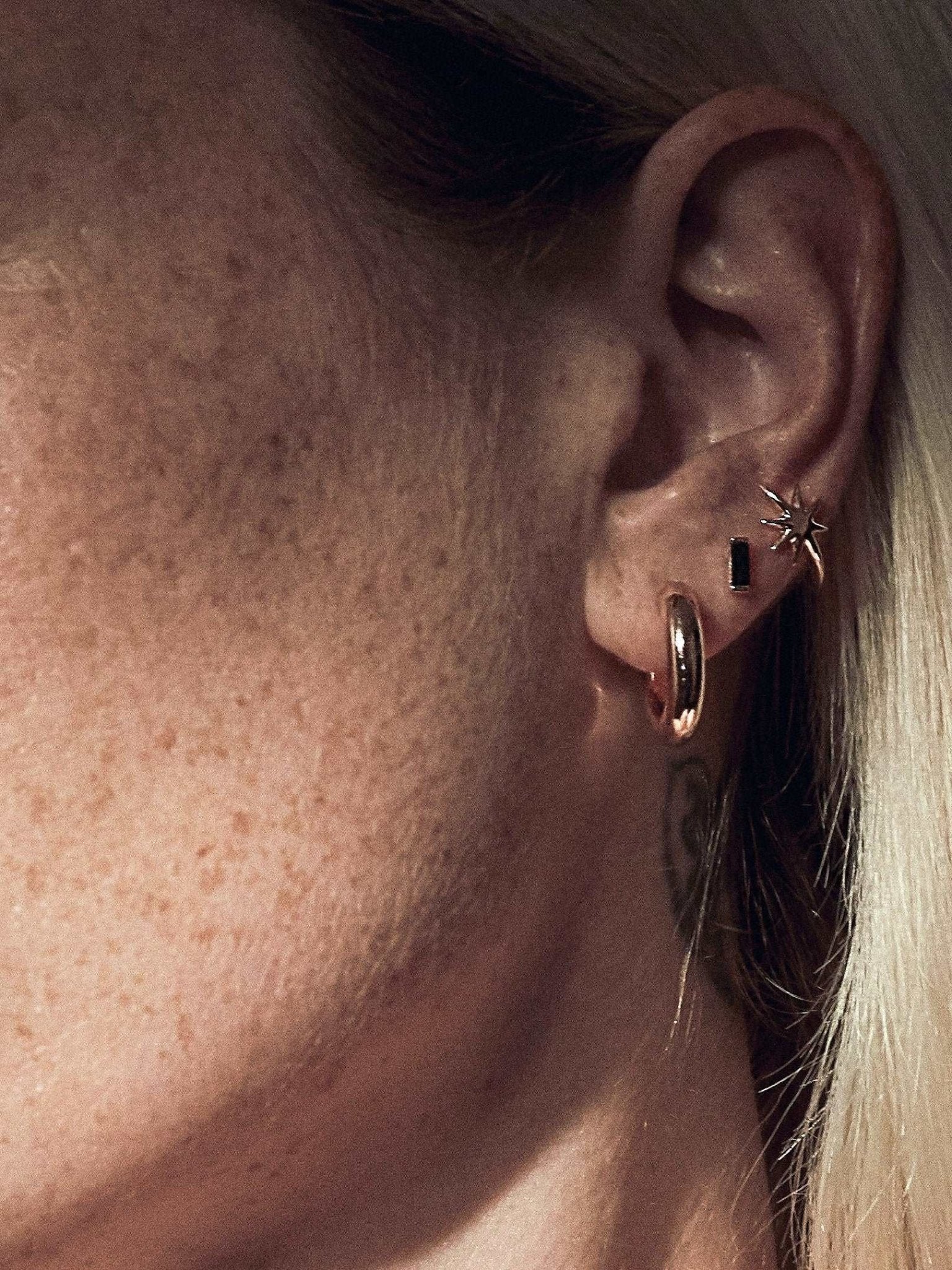 Single Birte open hoop earring in 24K gold plated finish — polished and sculptural shape.