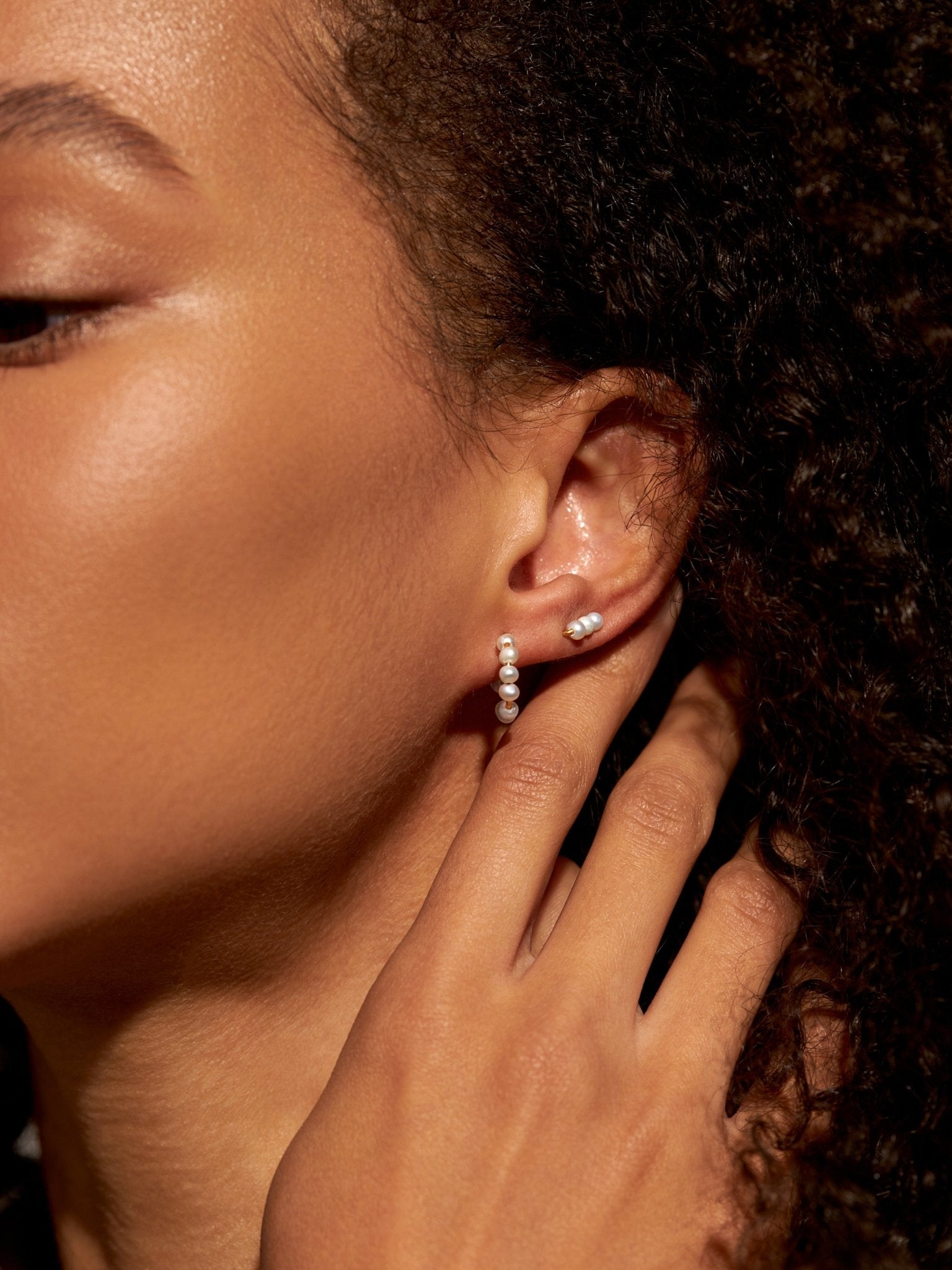 Model wearing Blanca elegant small pearl hoop earrings – sterling silver with pearl detail, elegant and timeless design