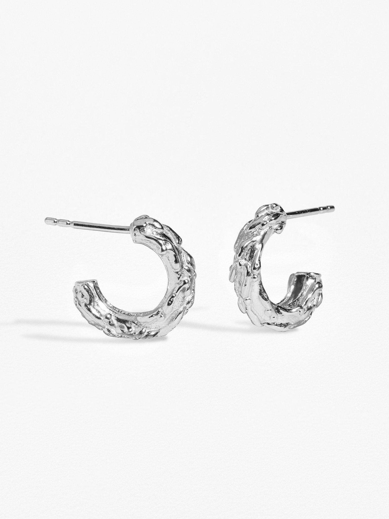 Groessa Raw Texture Open Hoop Earrings in silver, perfect for any occasion.
