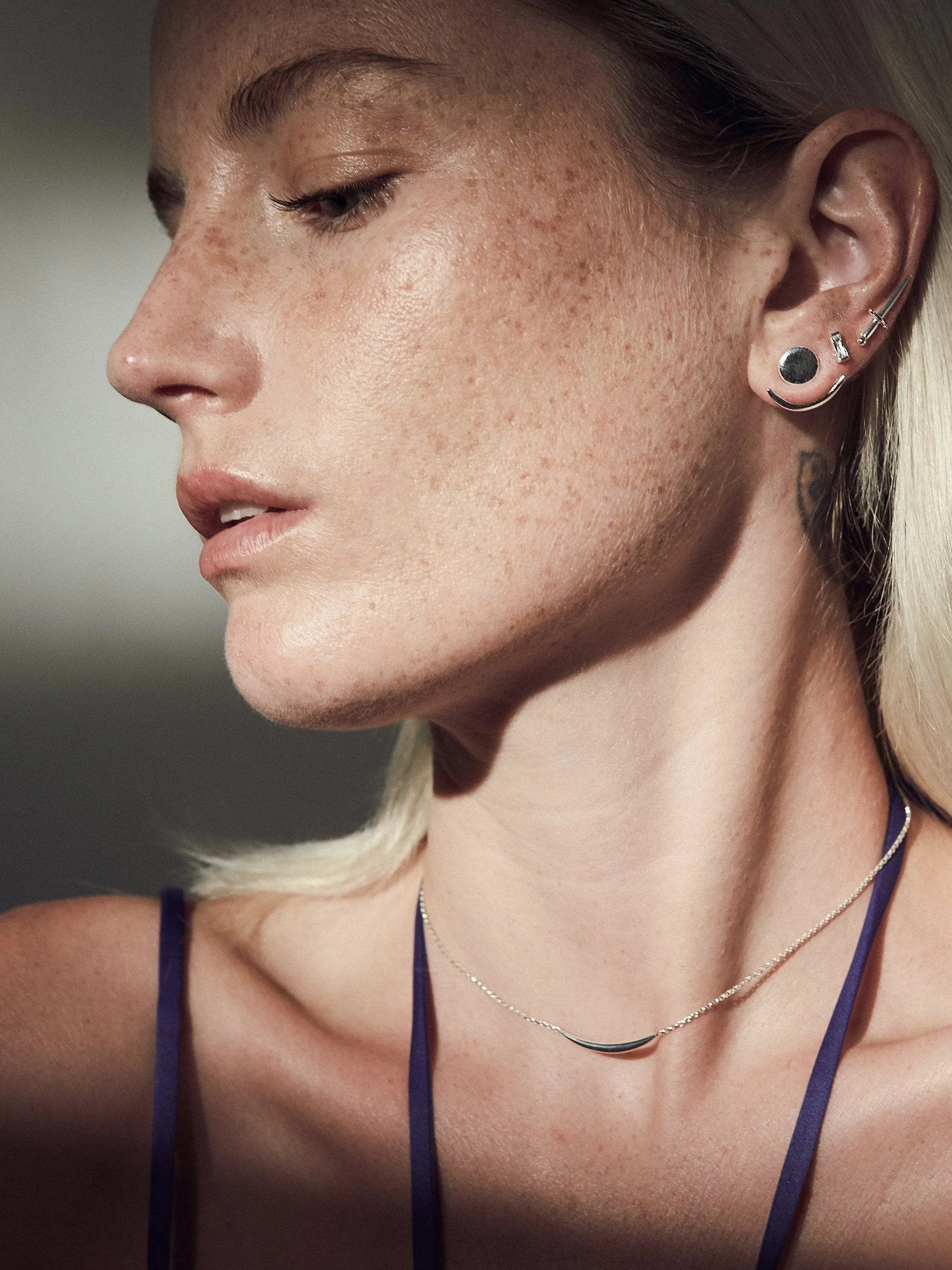  Sterling silver shiny ear jackets with a darkened finish, worn by a model with a minimalist necklace.