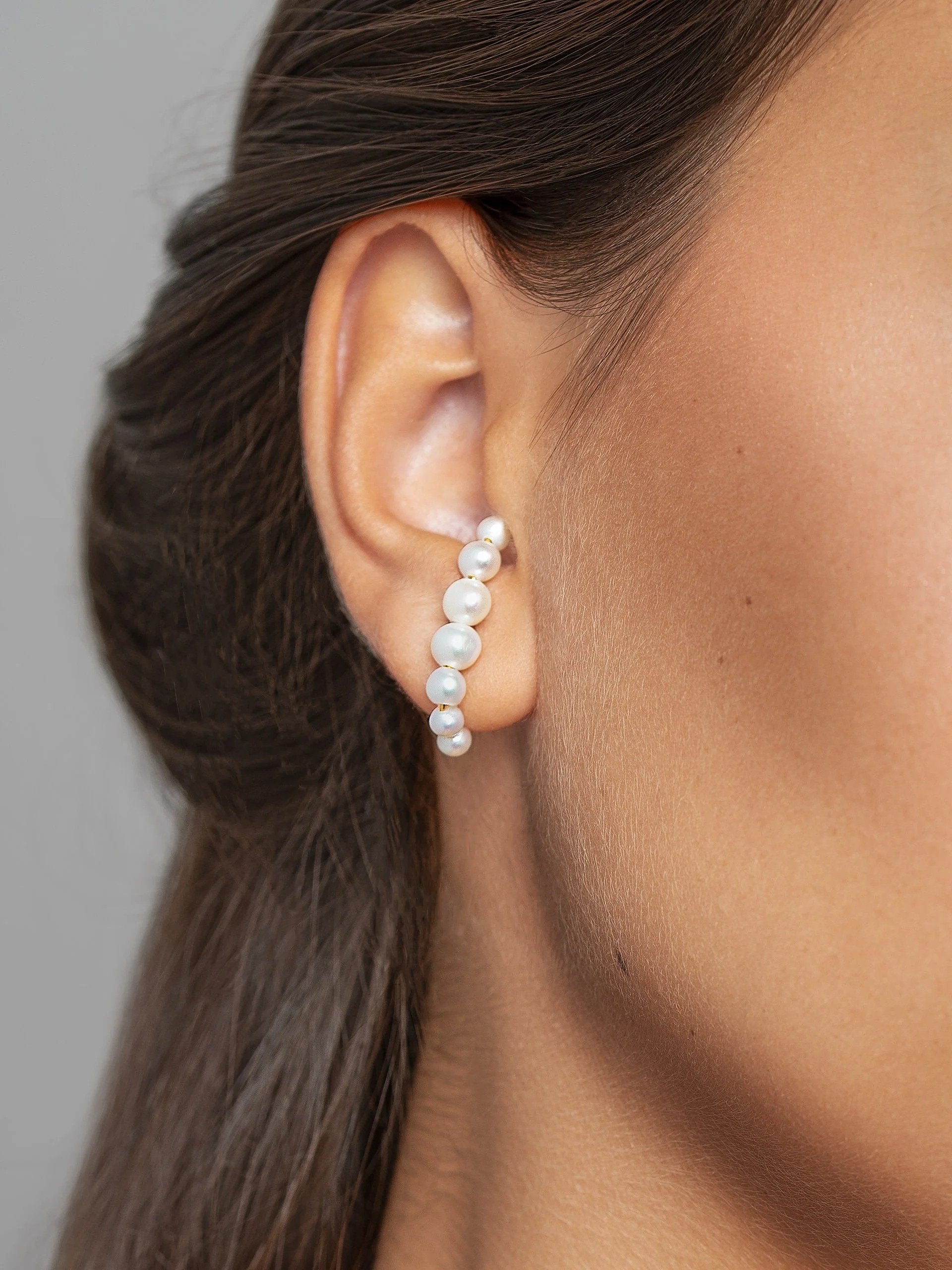 Model facing forward wearing the handmade Solene ear cuff, highlighting its minimalist and modern design.
