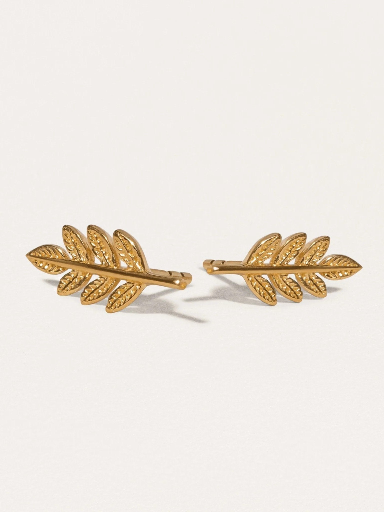 Gudrun Greek leaf stud earrings in 24K gold plated — intricate nature-inspired design on neutral background.