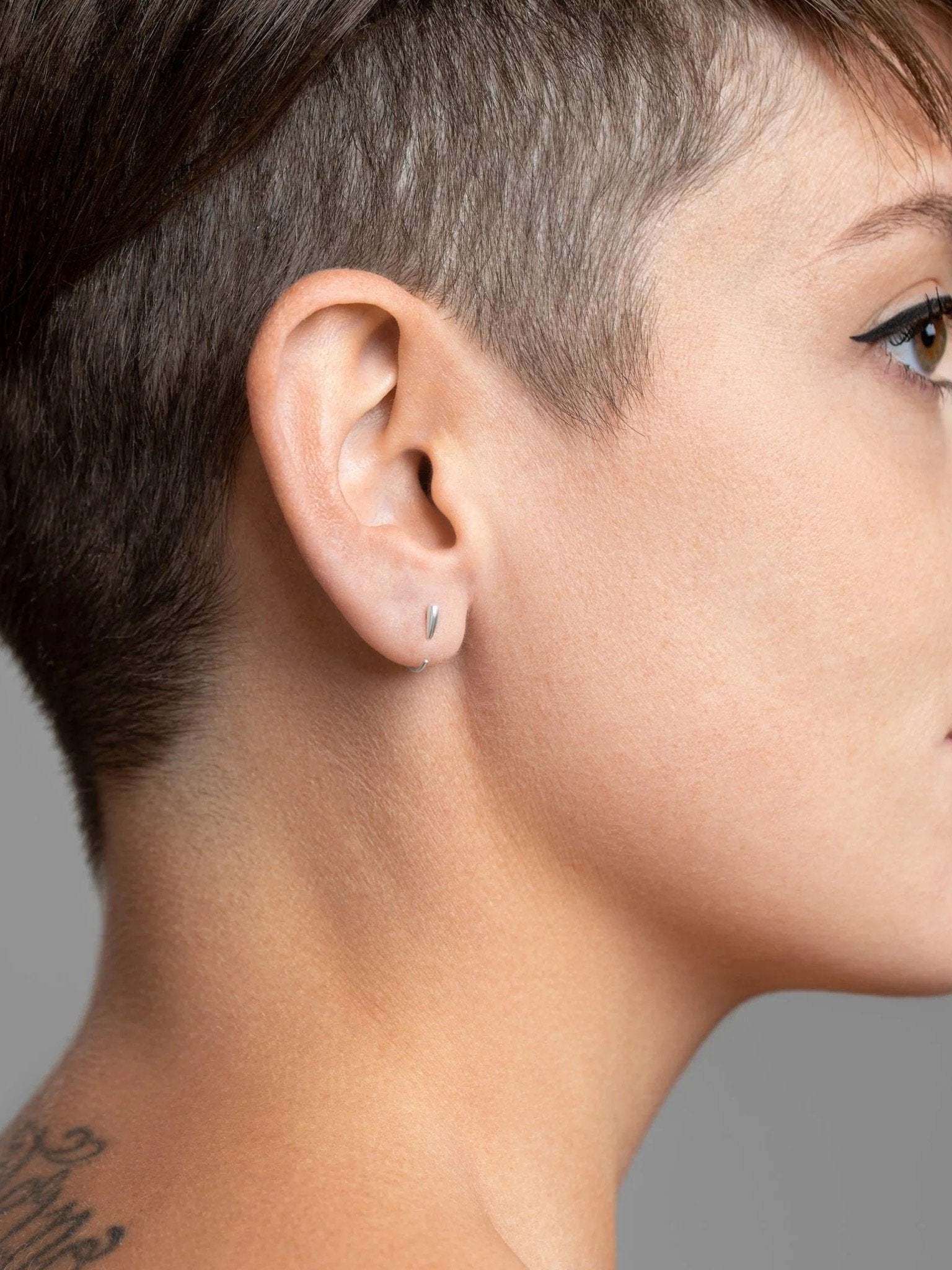 Sterling silver Luppa earring worn — tusk-inspired form with refined minimalism.