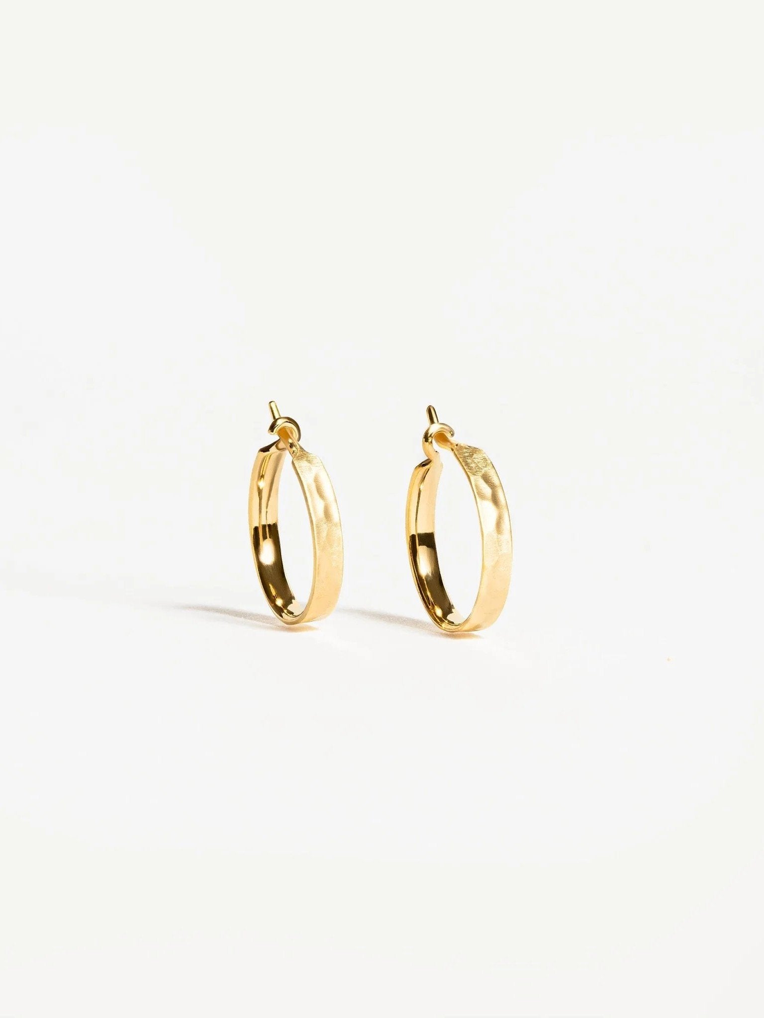 Nanna hammered huggie earrings in matte 24K gold plated — small round shape with textured detail.