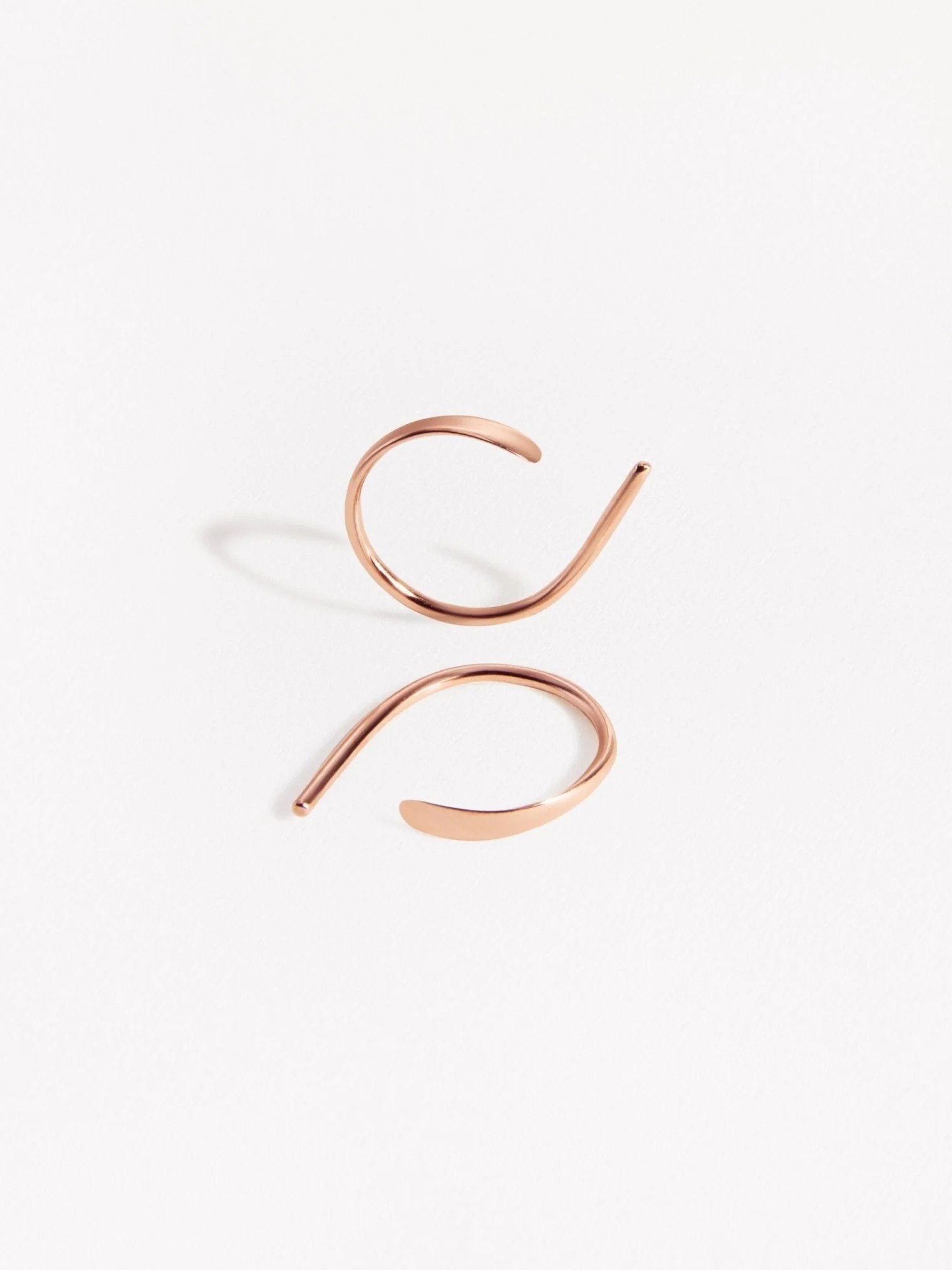 Rose gold version of Noe hammered hoop earrings — delicate and luminous design handmade in sterling silver.