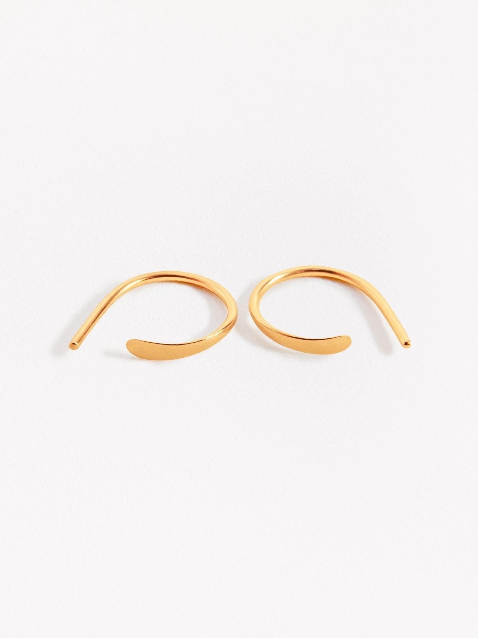 Noe hoop earrings in gold — gently curved and hammered front, shown side by side on white backdrop.