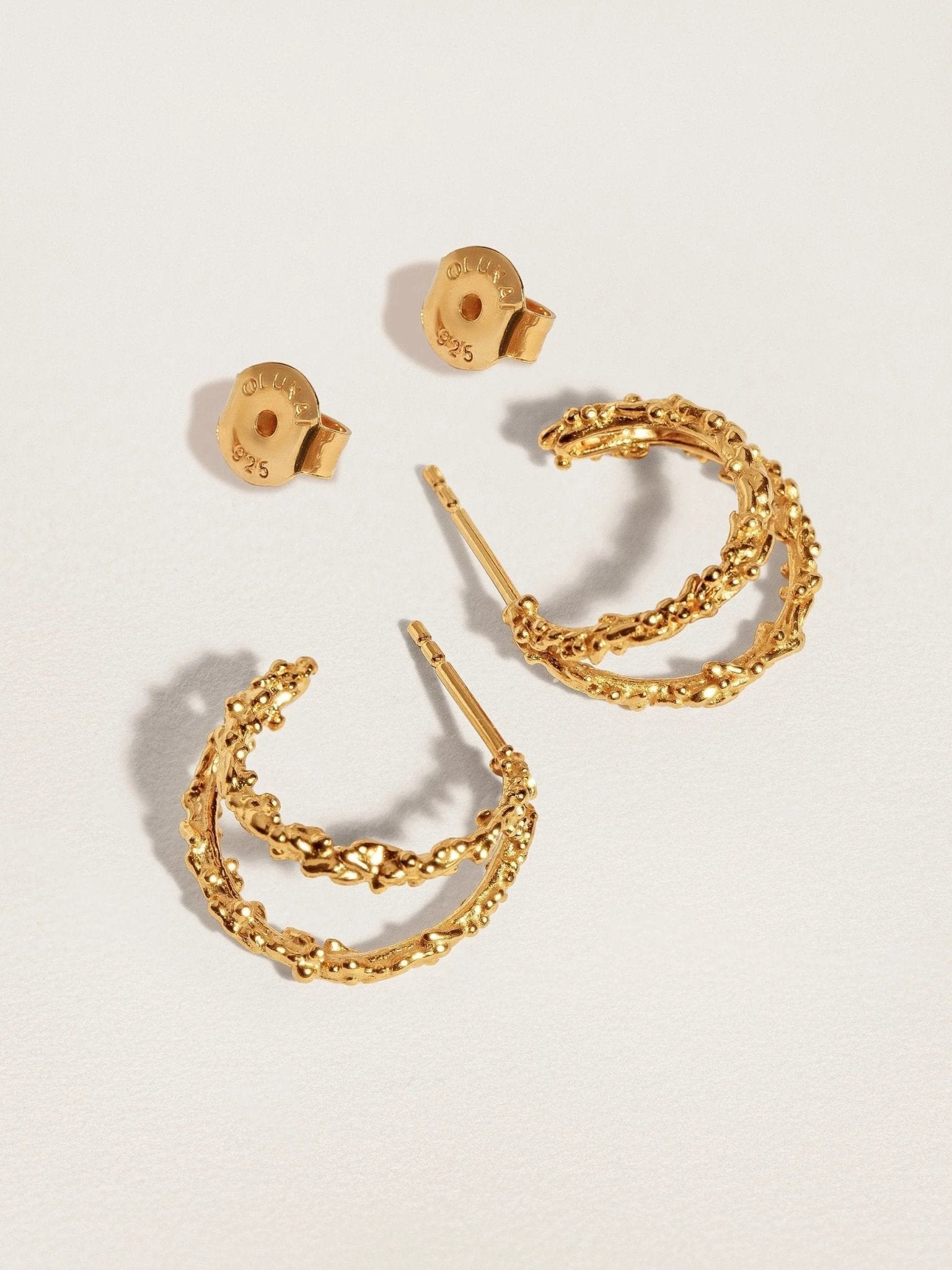 Close-up of the hypoallergenic stud of the Priana Gold Double Hoop Earrings.