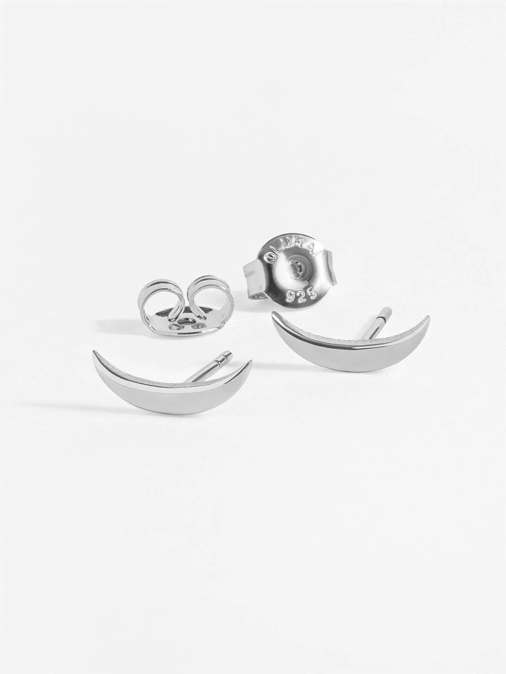 Silver crescent stud earring set of three displayed flat