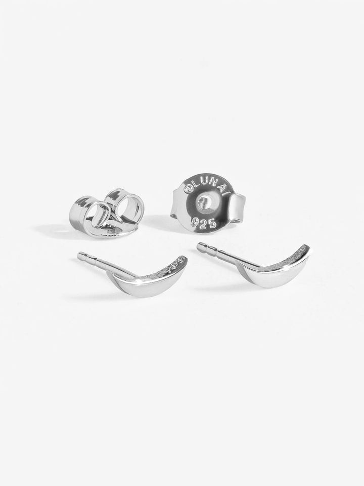 Two 925 sterling silver crescent moon stud earrings from three-piece set on white background