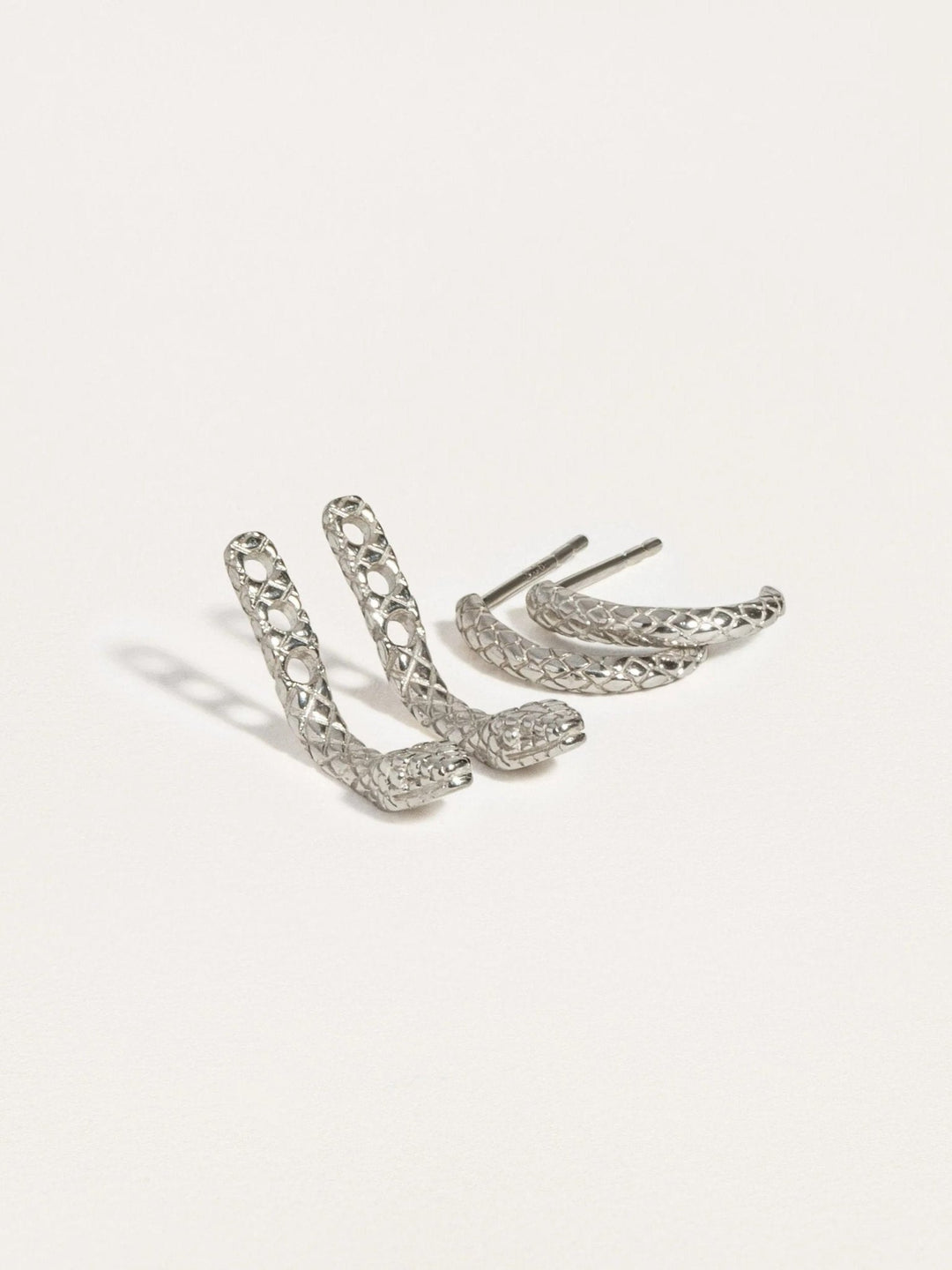  Pair of snake ear jackets in sterling silver raw and 24K gold plated, photographed on white background