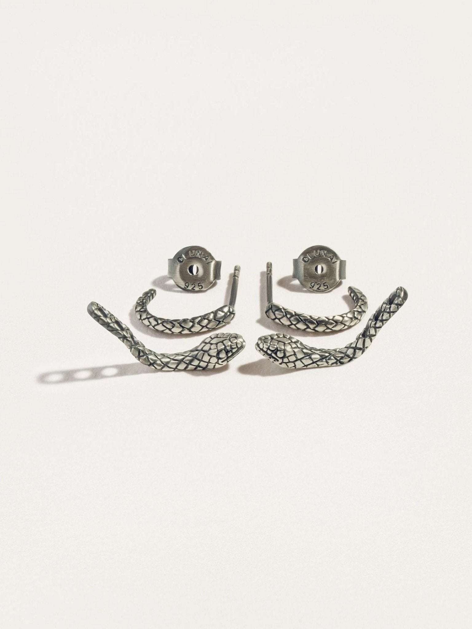  Sterling silver raw snake ear jacket set, laid out on a white surface with intricate details.