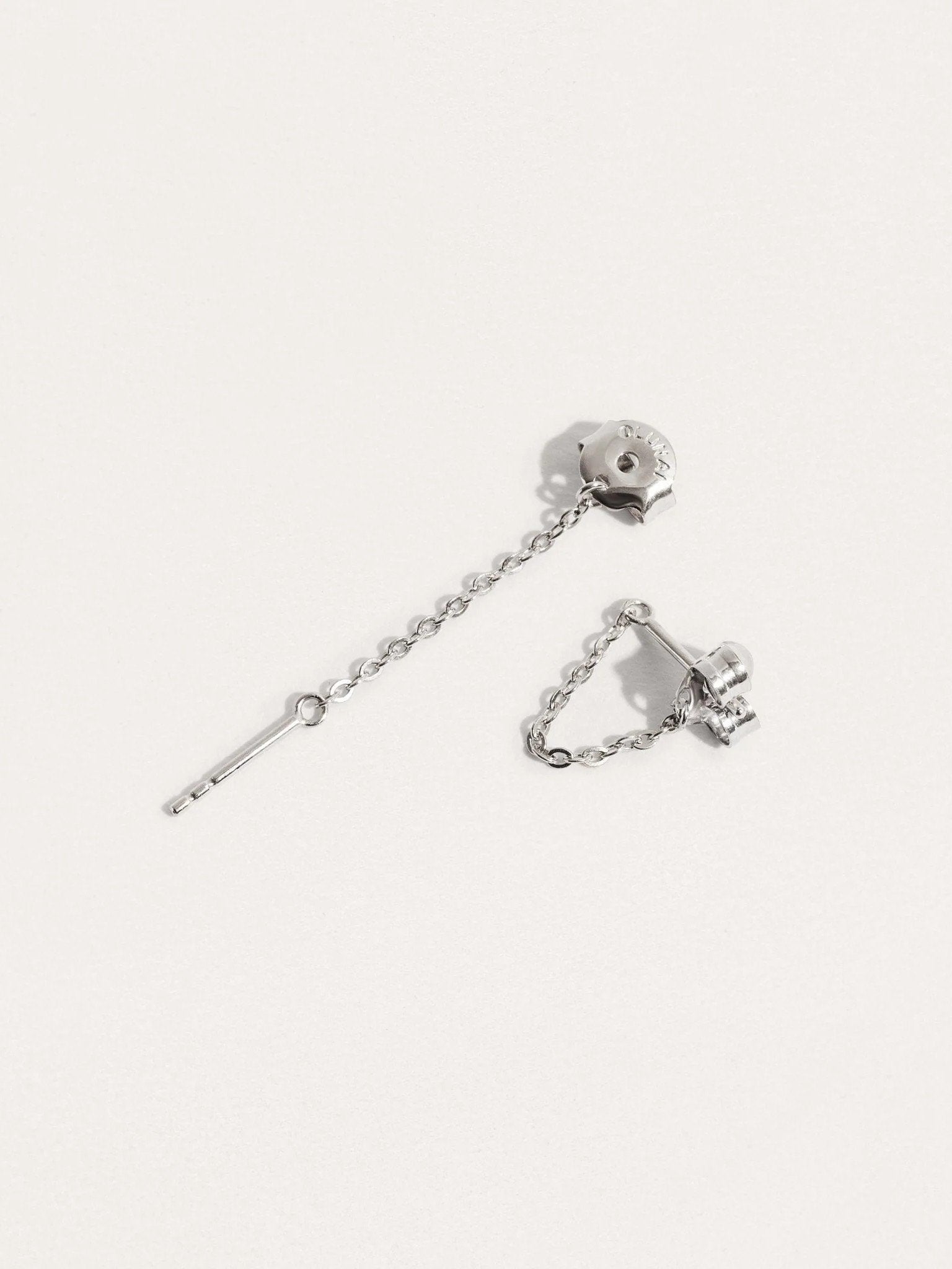 Sterling silver chain stud earrings on soft background