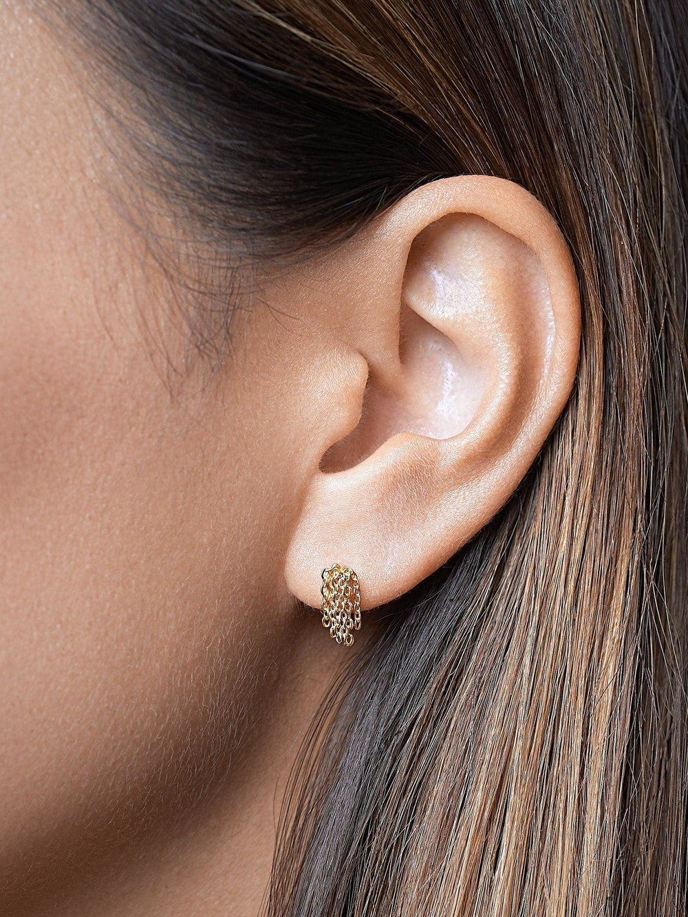 	Model wearing rose gold tassel drop earrings